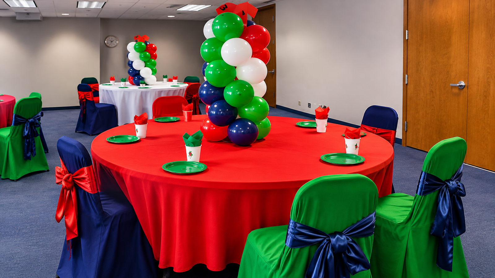 Red, green and navy balloon columns on round tables with matching chair covers