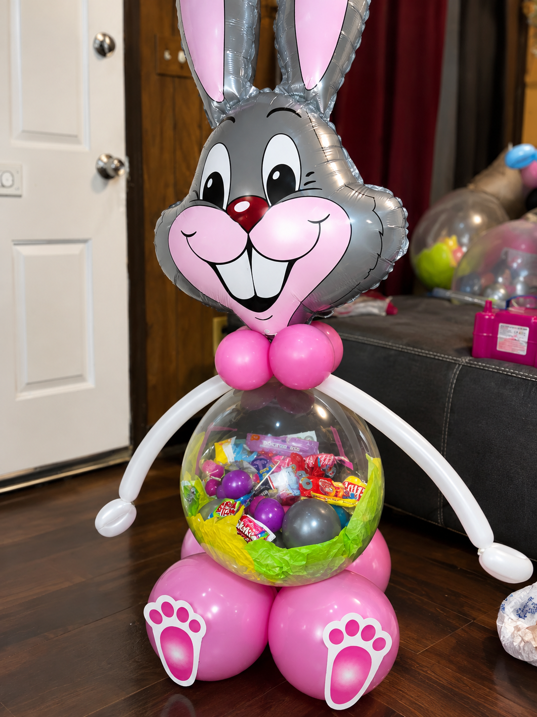 Easter bunny balloon figure with a clear candy-filled balloon body