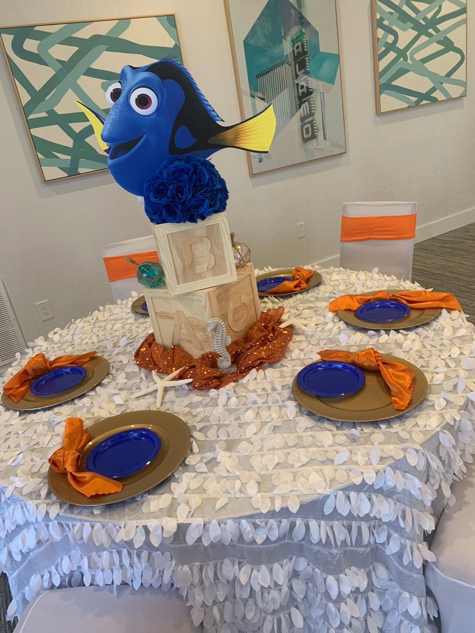Ocean themed baby shower table with ABC block centerpiece and orange napkins
