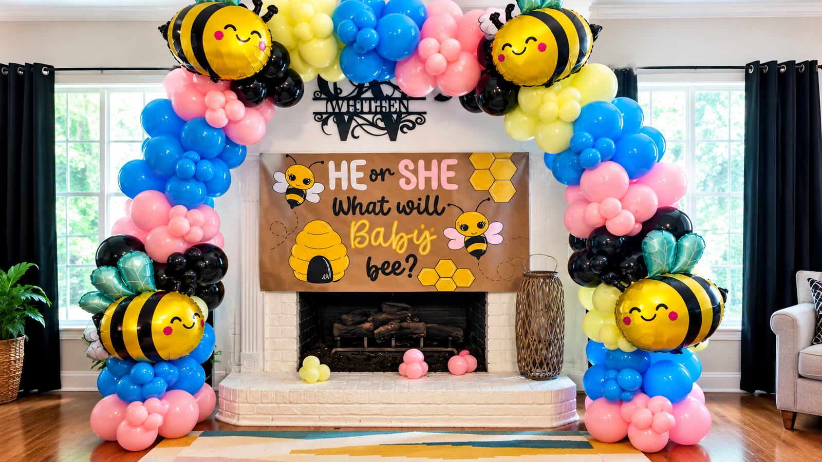 Full balloon arch in pink, blue, yellow and black with bee balloons framing a gender reveal fireplace